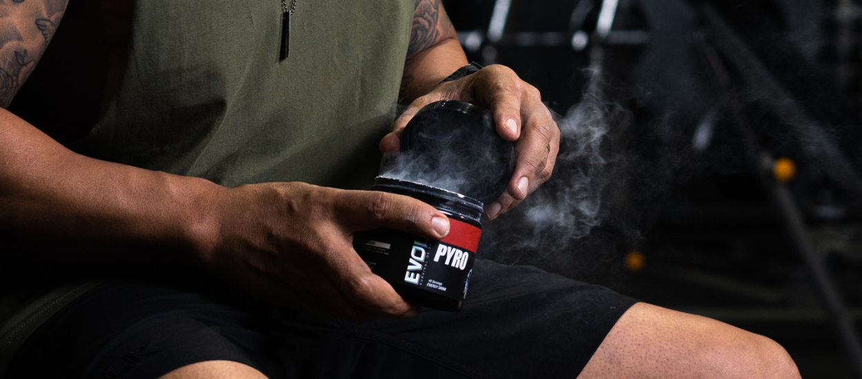 man holding tub of preworkout 