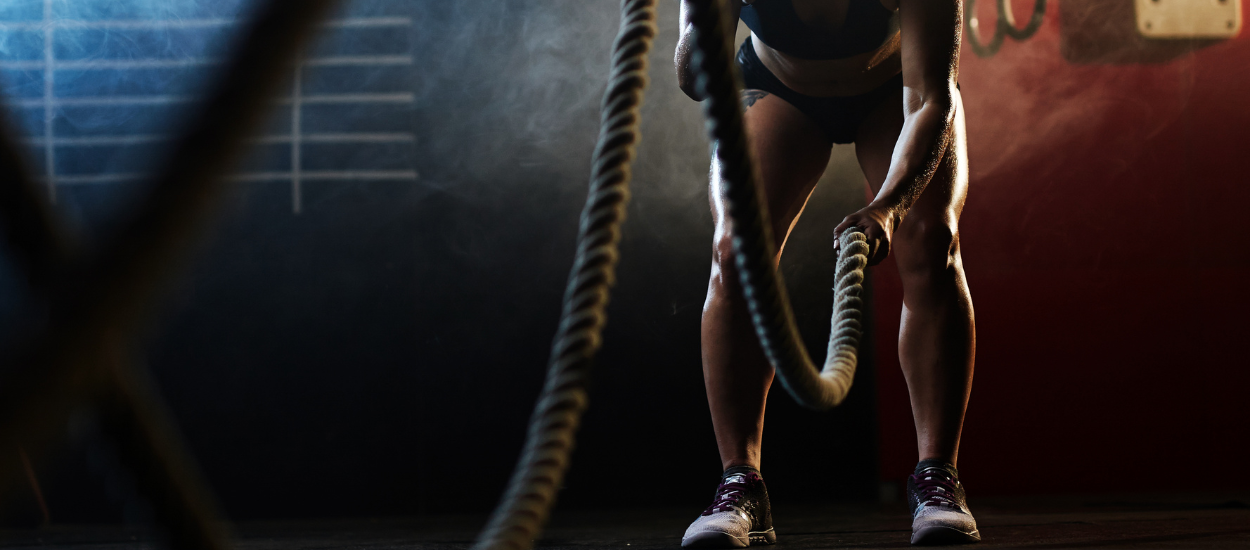 man in gym holding gym ropes