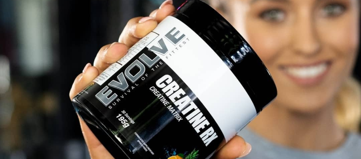 woman holding evolve creatine rx tub