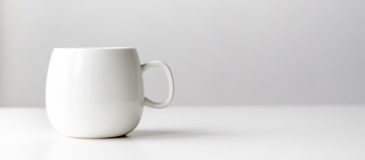 White ceramic mug on a white table