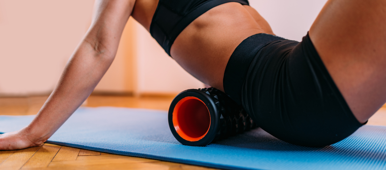woman using foam roller to stretch muscles