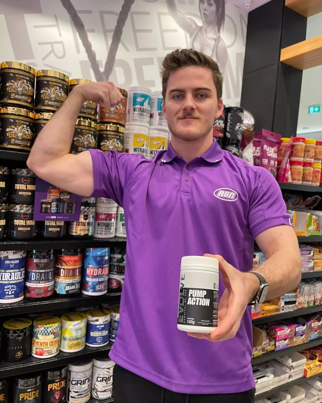 man in store holidng tub of preworkout